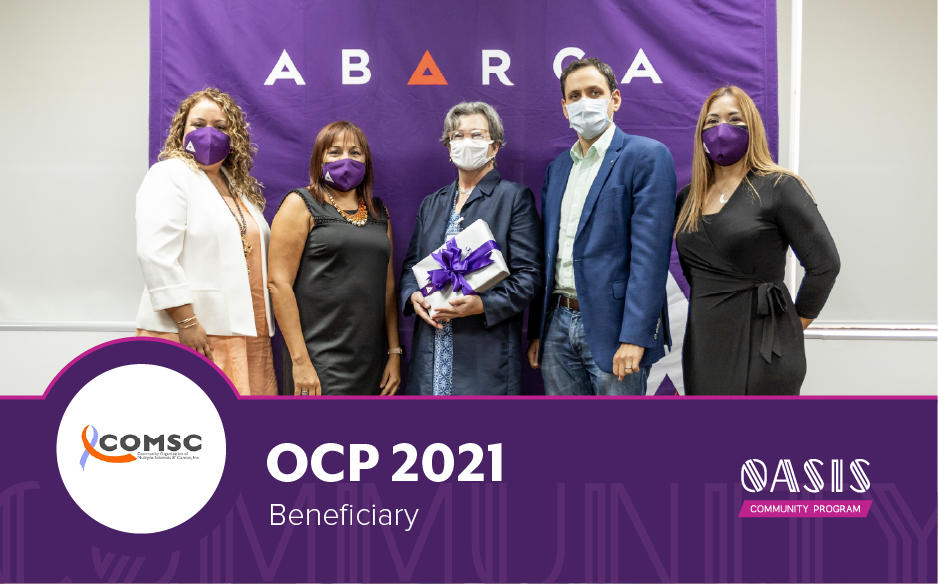 Abarca Health team presents OCP 2021 beneficiary recognition to COMSC representatives in front of a purple Oasis Community Program backdrop.